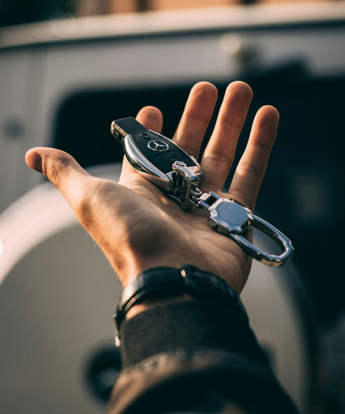 Hand holding car key